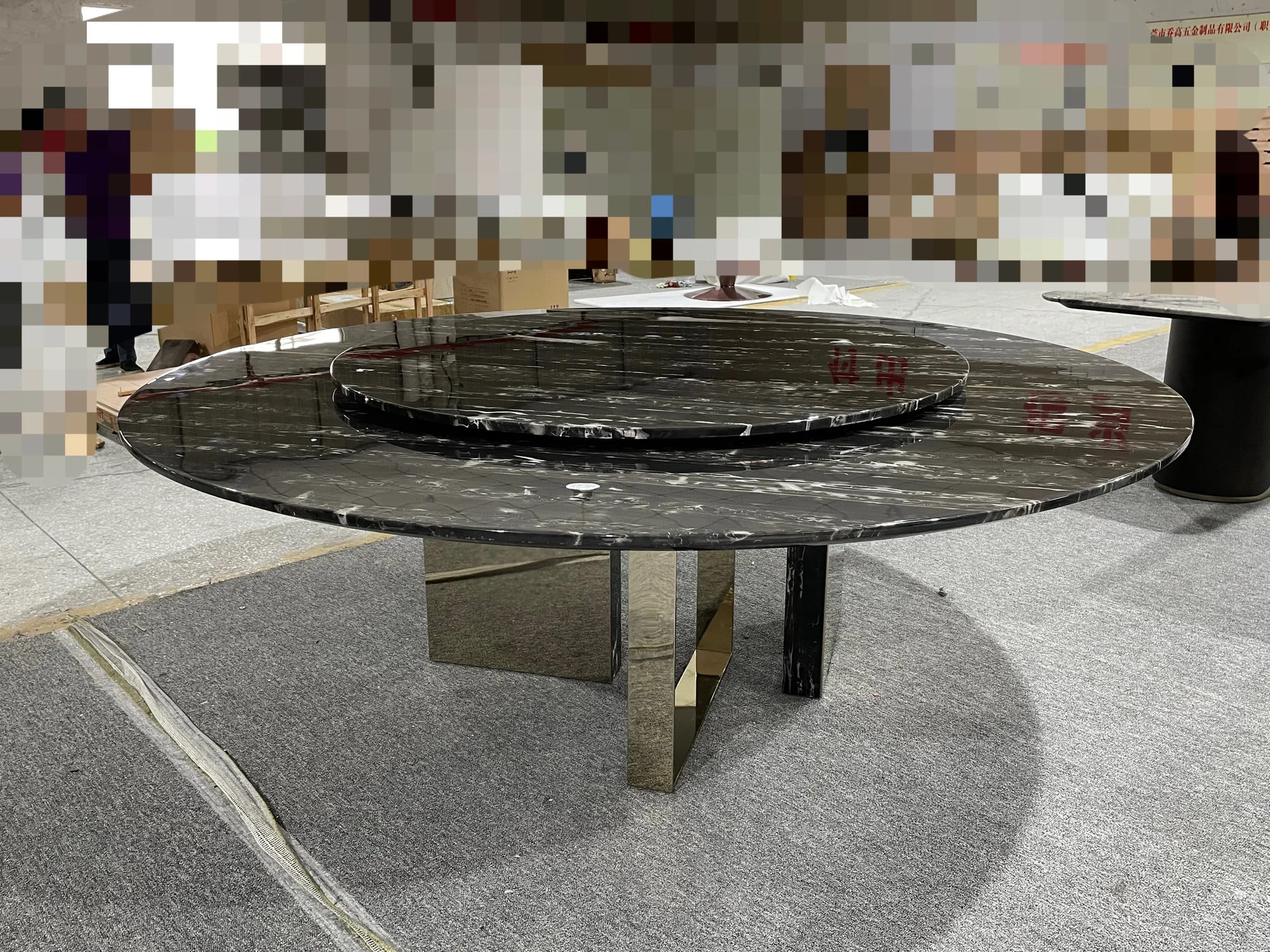 Black marble table on a brass base in a Foshan stone workshop