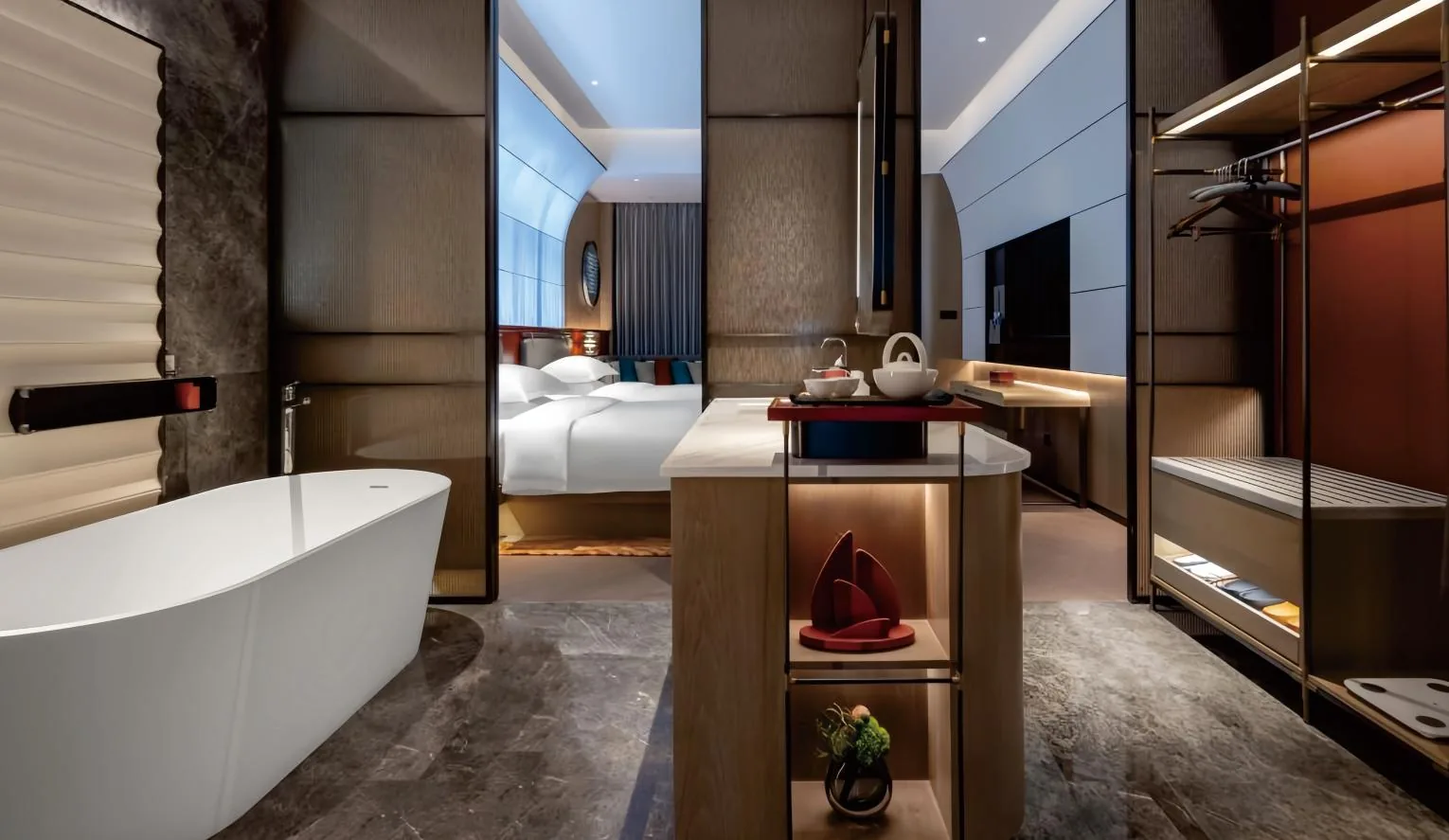 Hotel guestroom with king bed, desk and lounge chair