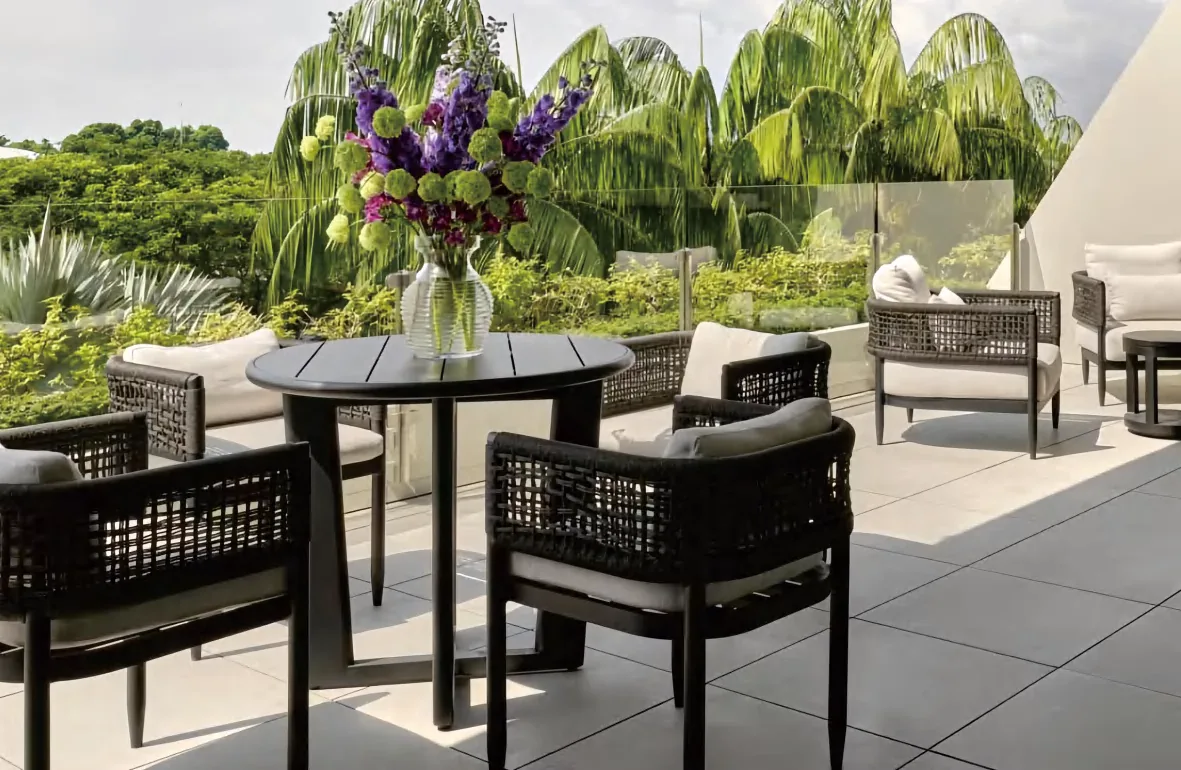 Terrace dining set in dark aluminium under trees