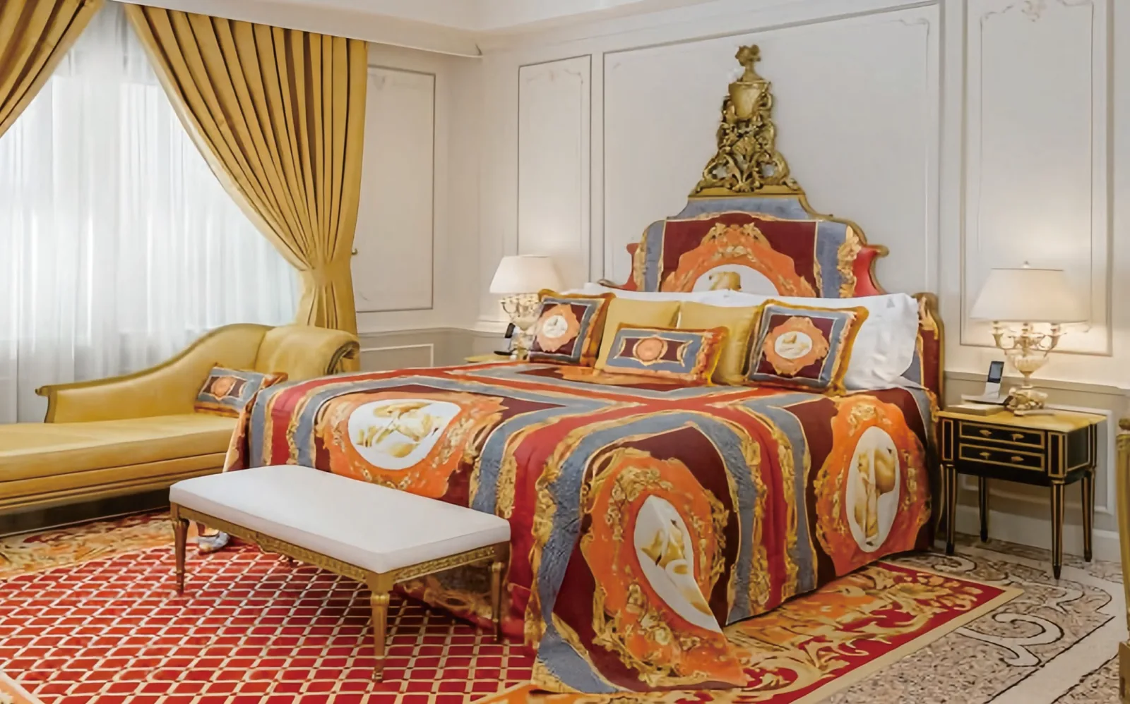 Luxury suite bedroom with patterned headboard and lounge seating