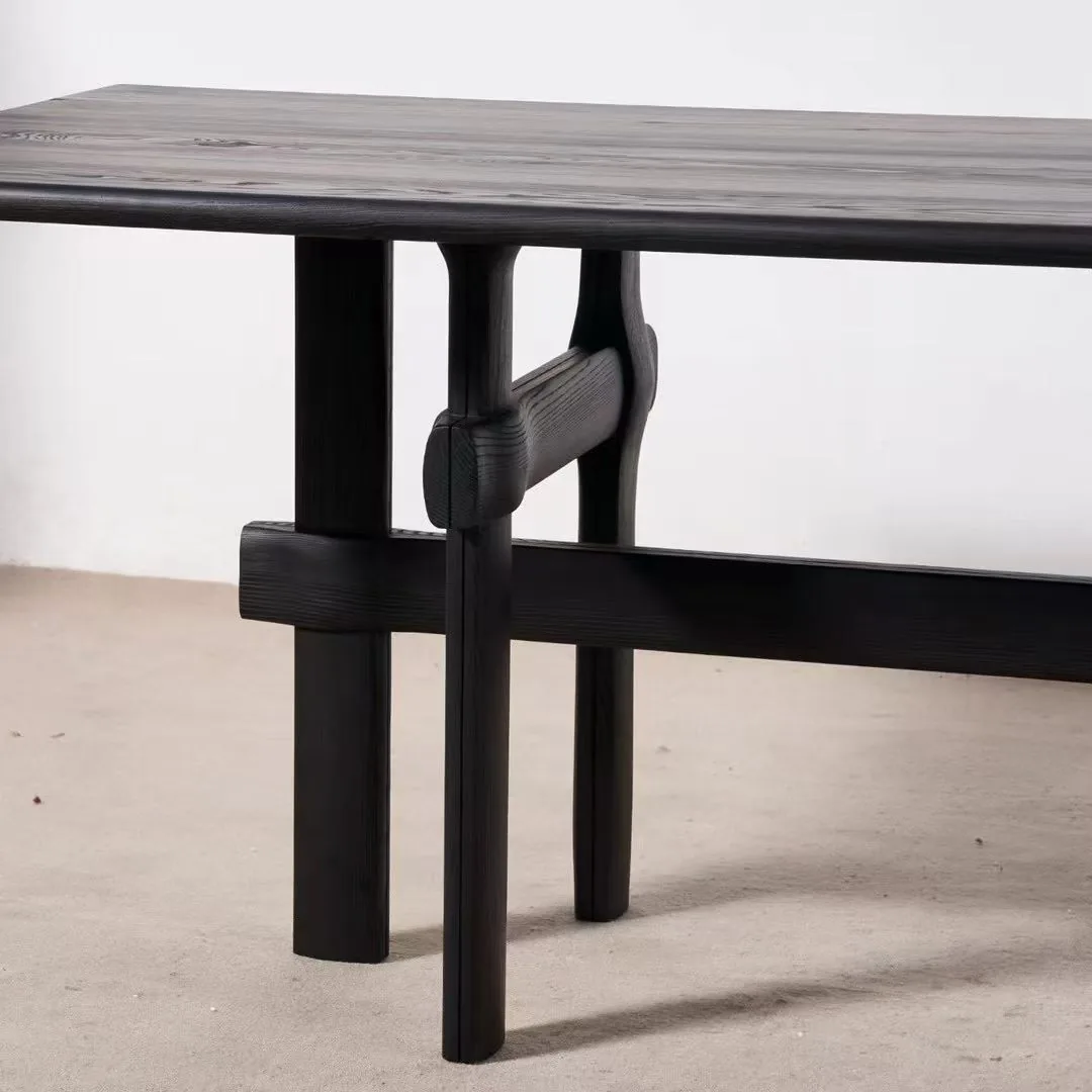 Black stained oak dining table with sculptural trestle base