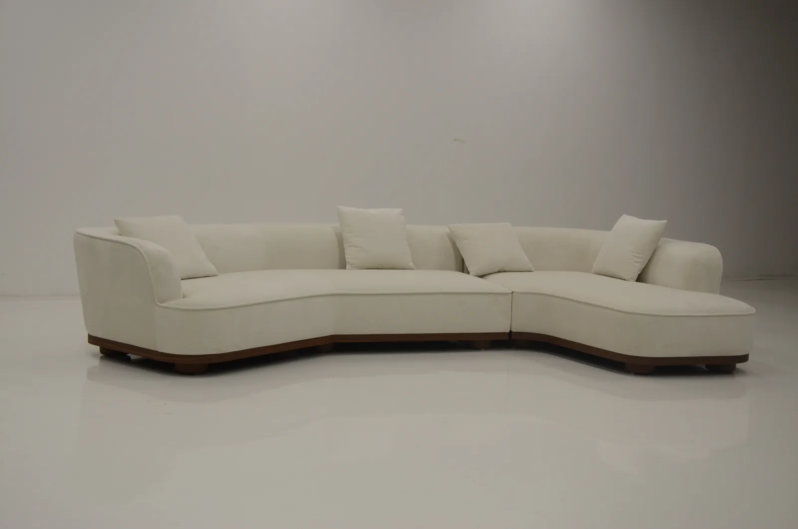 Curved cream boucle sofa in the studio