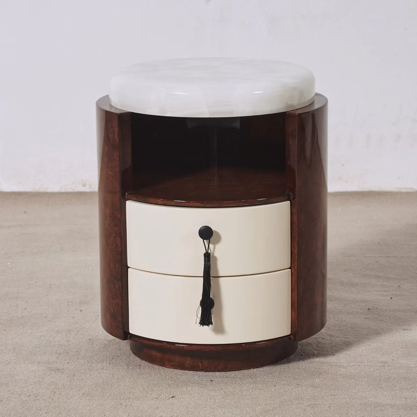 Round burl nightstand with onyx top and tassel pulls