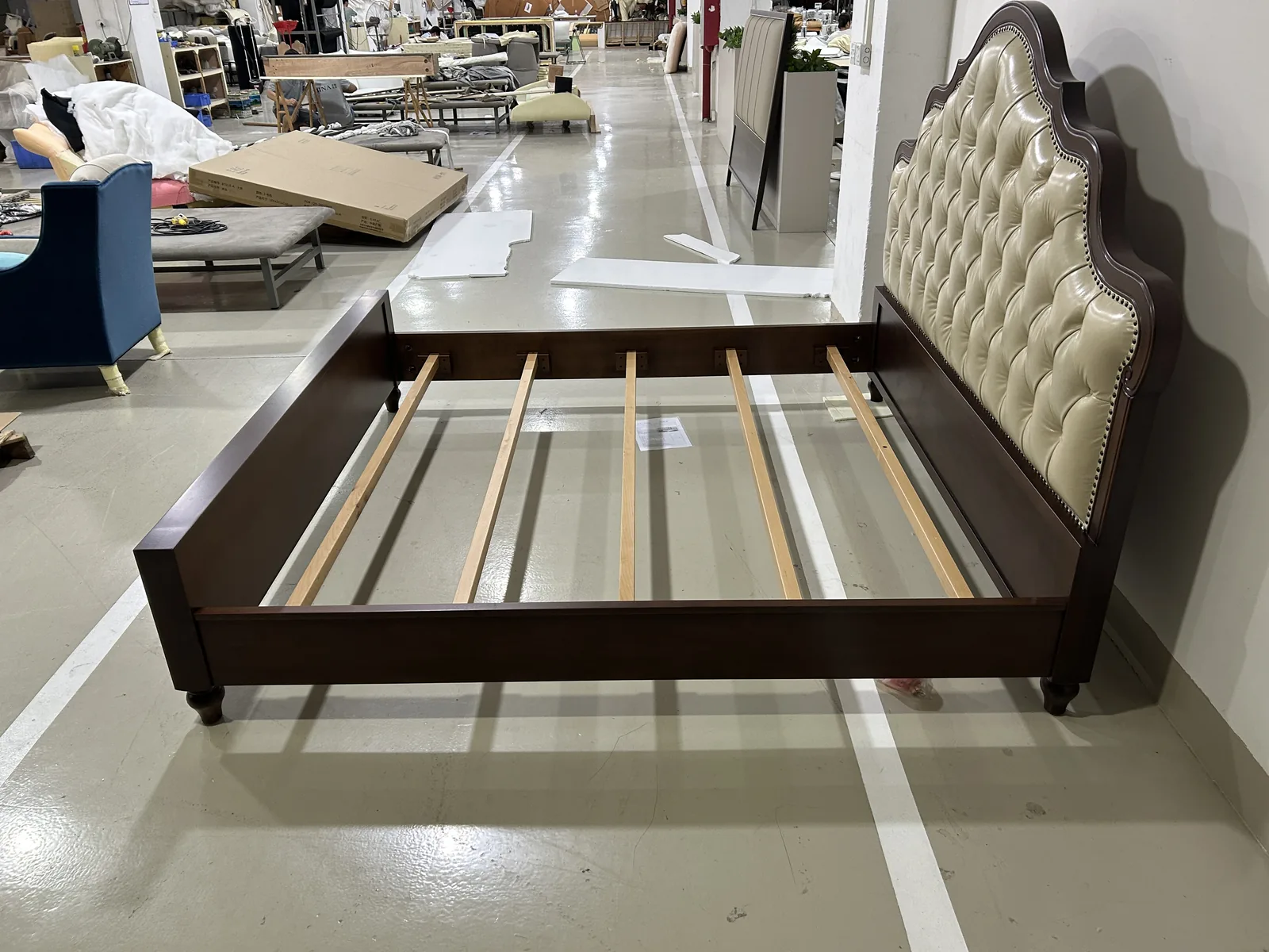 Rows of bare timber sofa frames in a Foshan upholstery factory