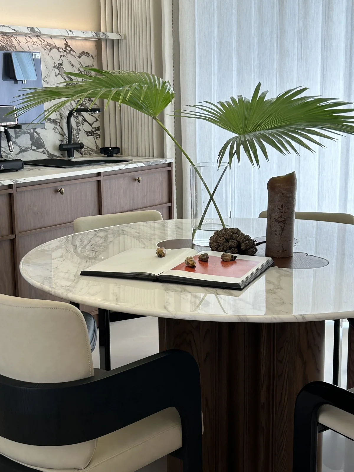 Round marble dining table with chairs in a showroom