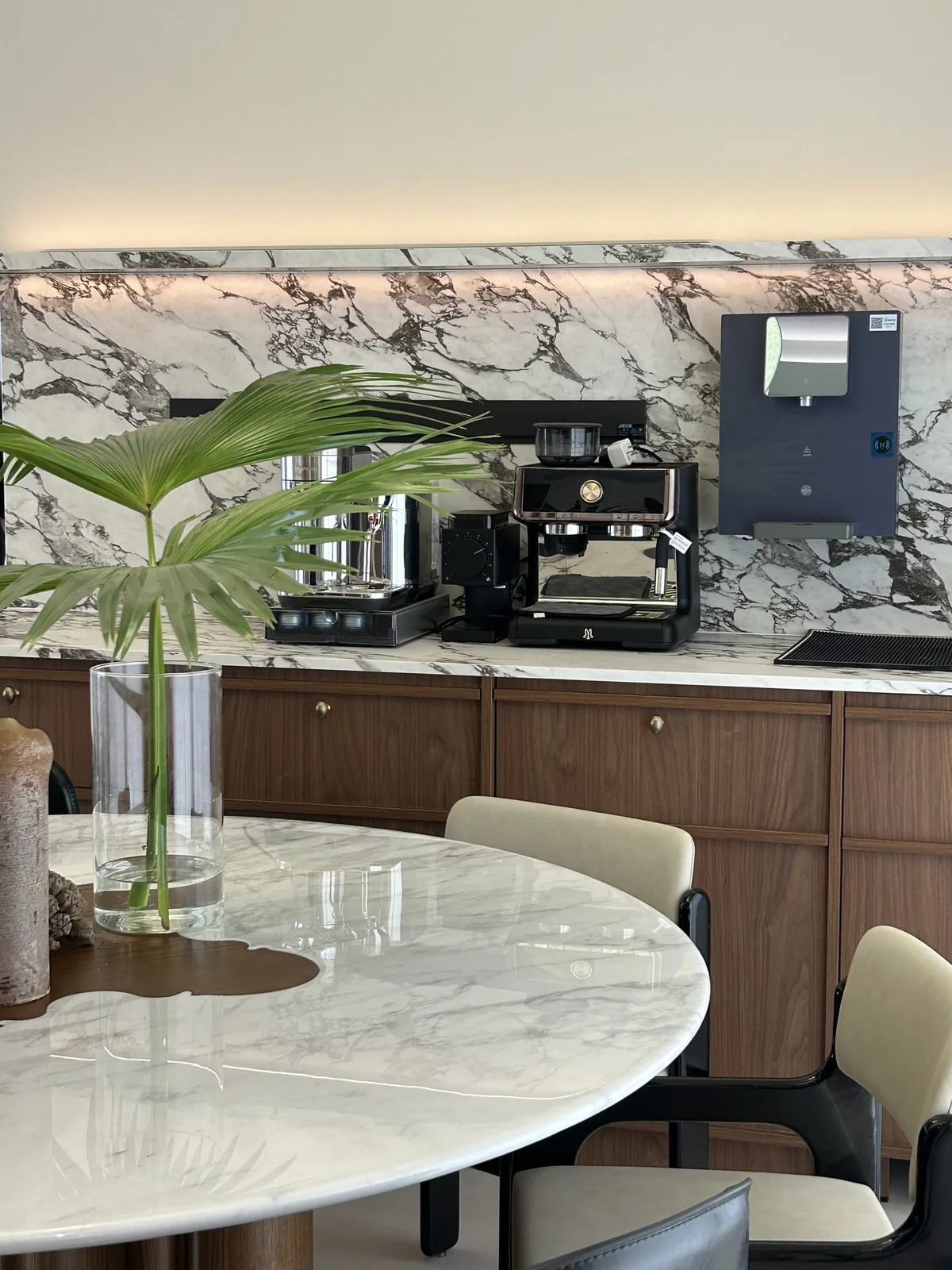Stone dining table with chairs displayed in a Foshan showroom
