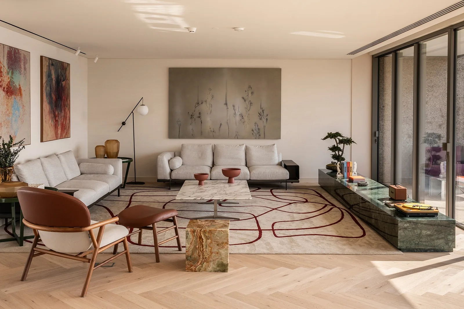 Large living room with cream sofas and lounge chairs around a low table