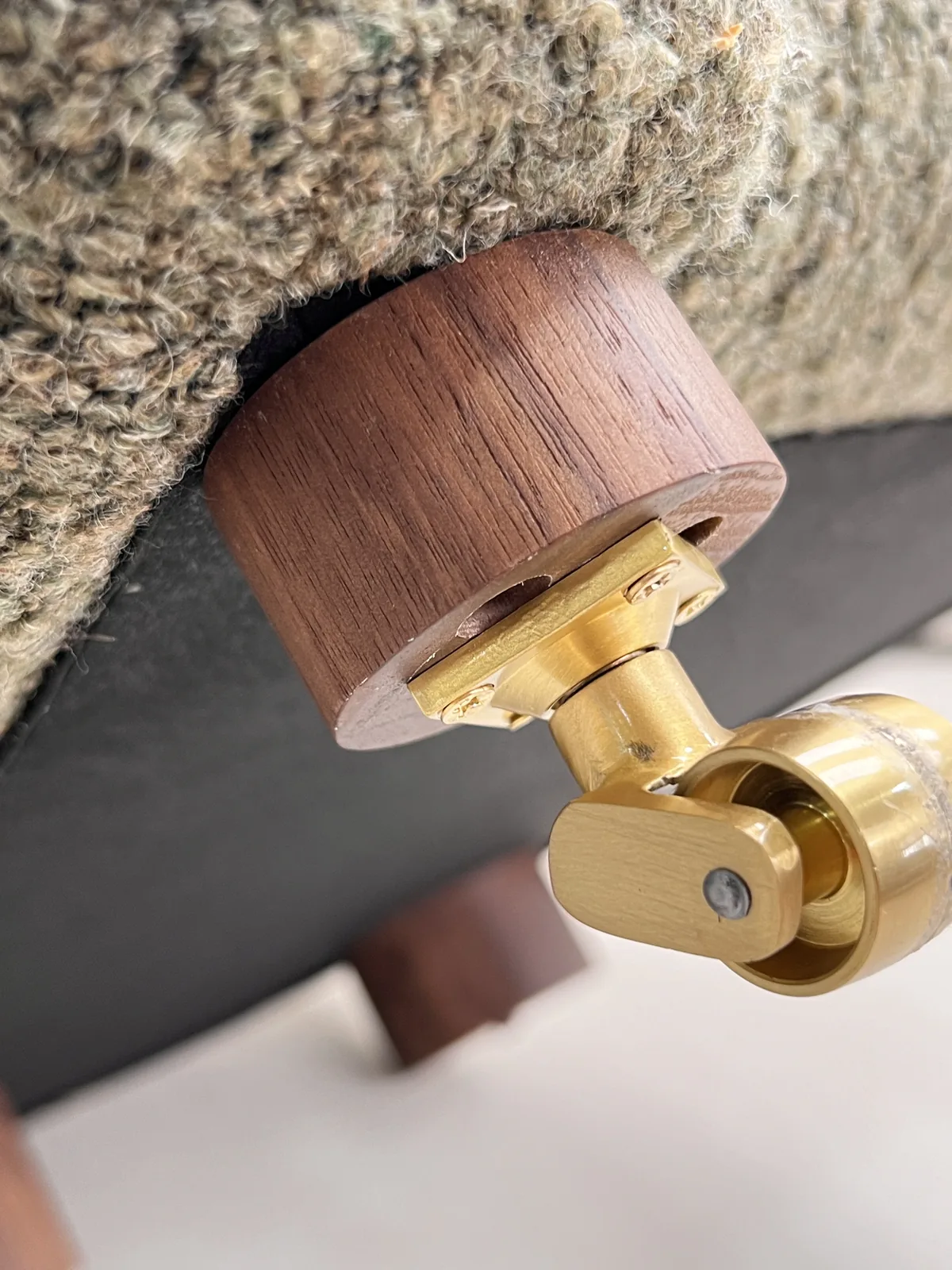 Brass swivel foot and walnut base inspected before packing