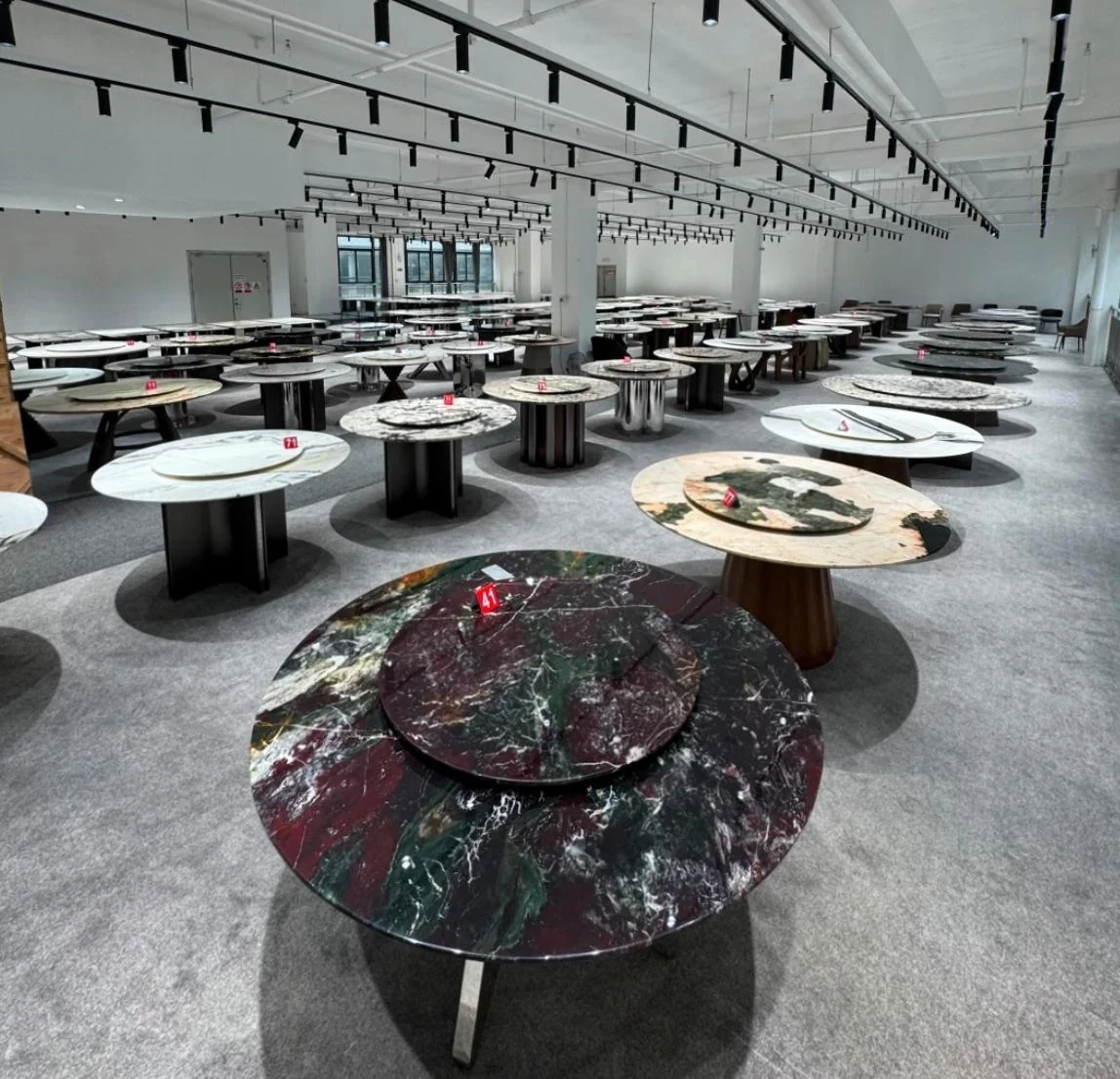 Stone dining tables displayed for in-person supplier selection in Foshan