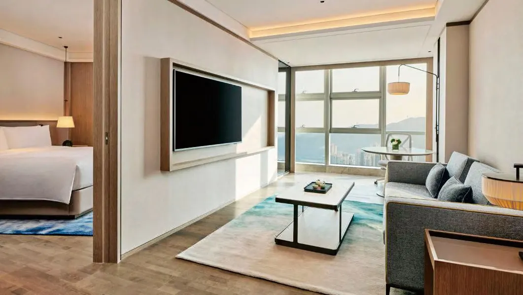 Serviced-apartment style living room with sofa and storage wall