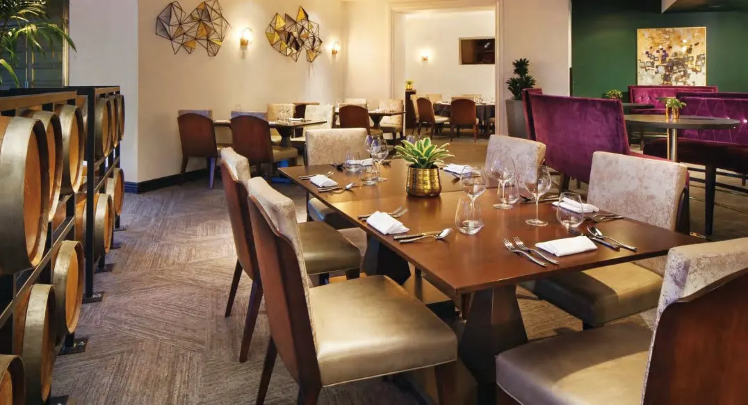 Hotel restaurant private table with upholstered chairs