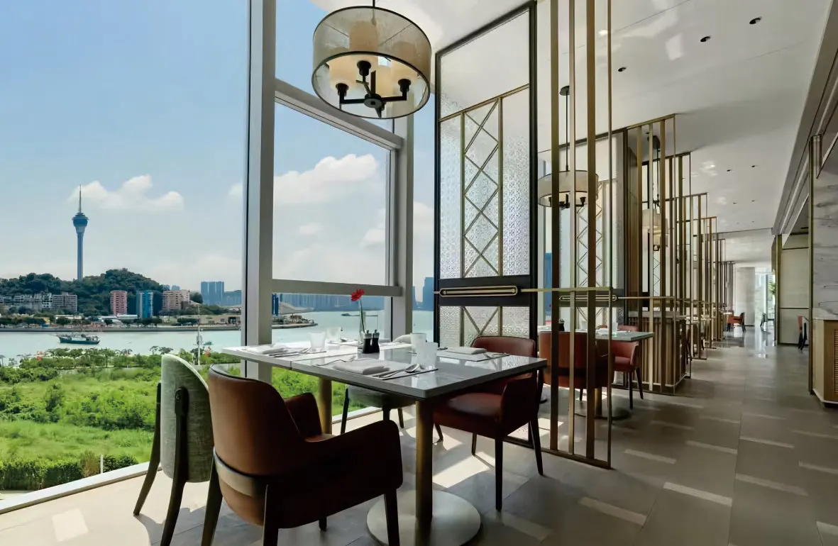 Hotel restaurant with dining chairs and river view