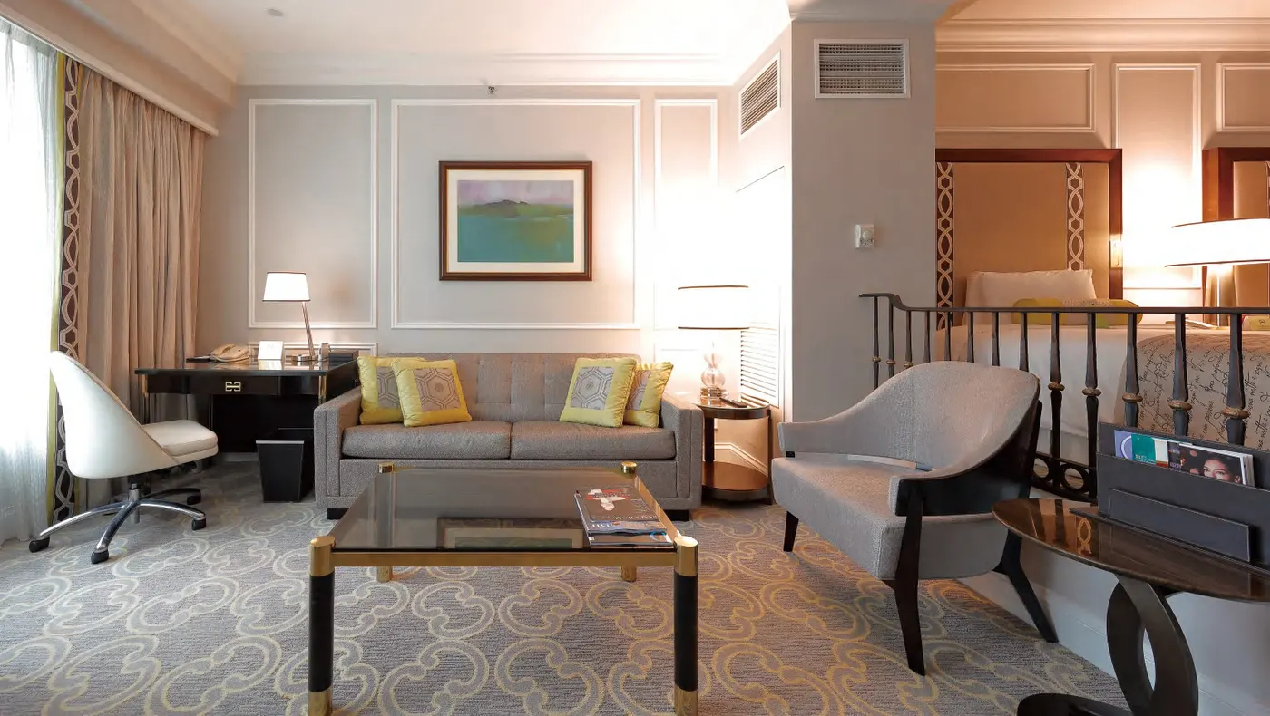 Hotel suite with desk, sofa and lounge chair