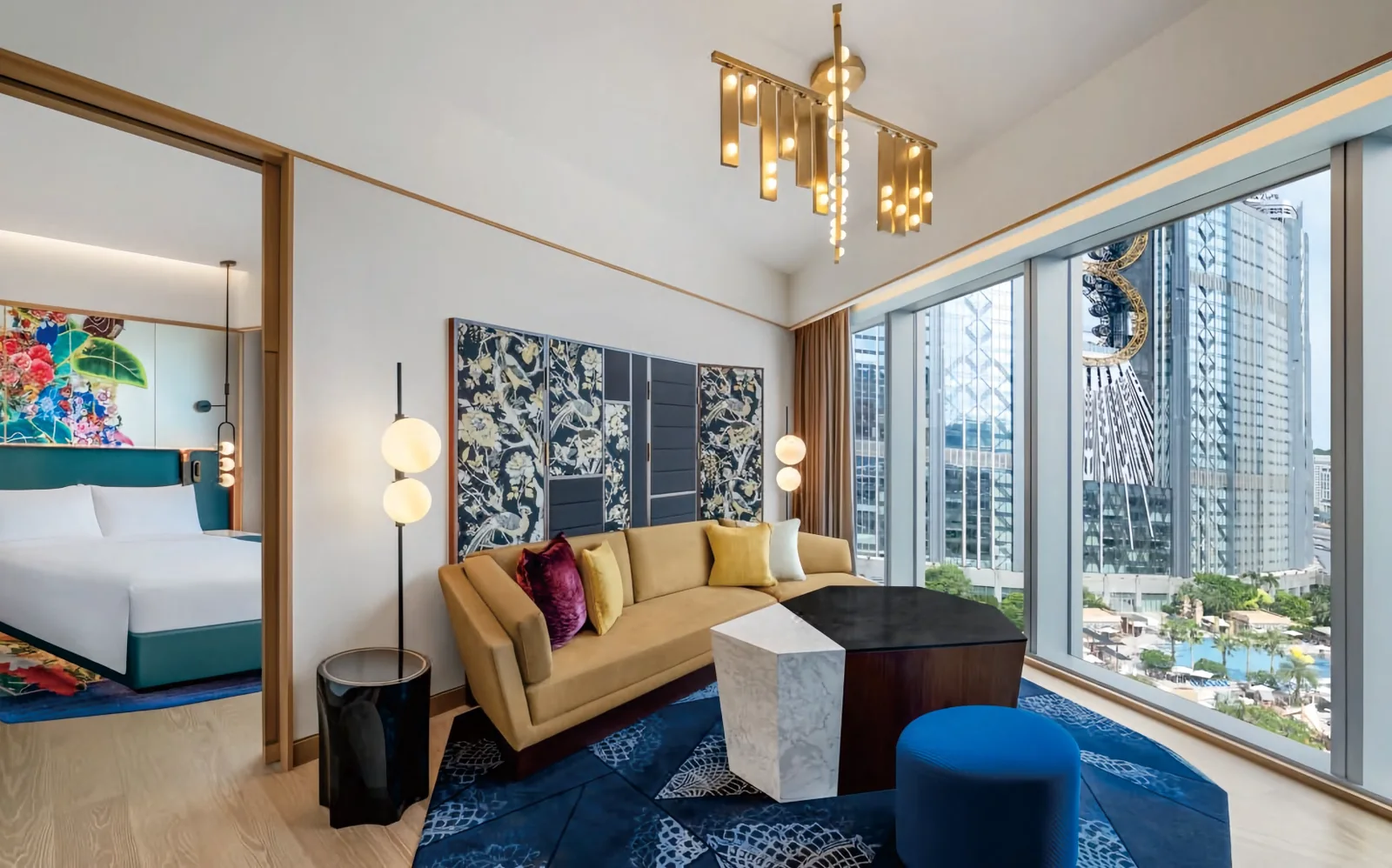 Hotel guestroom with teal upholstered bed, floral headboard art and city view, produced by a Foshan hospitality furniture factory