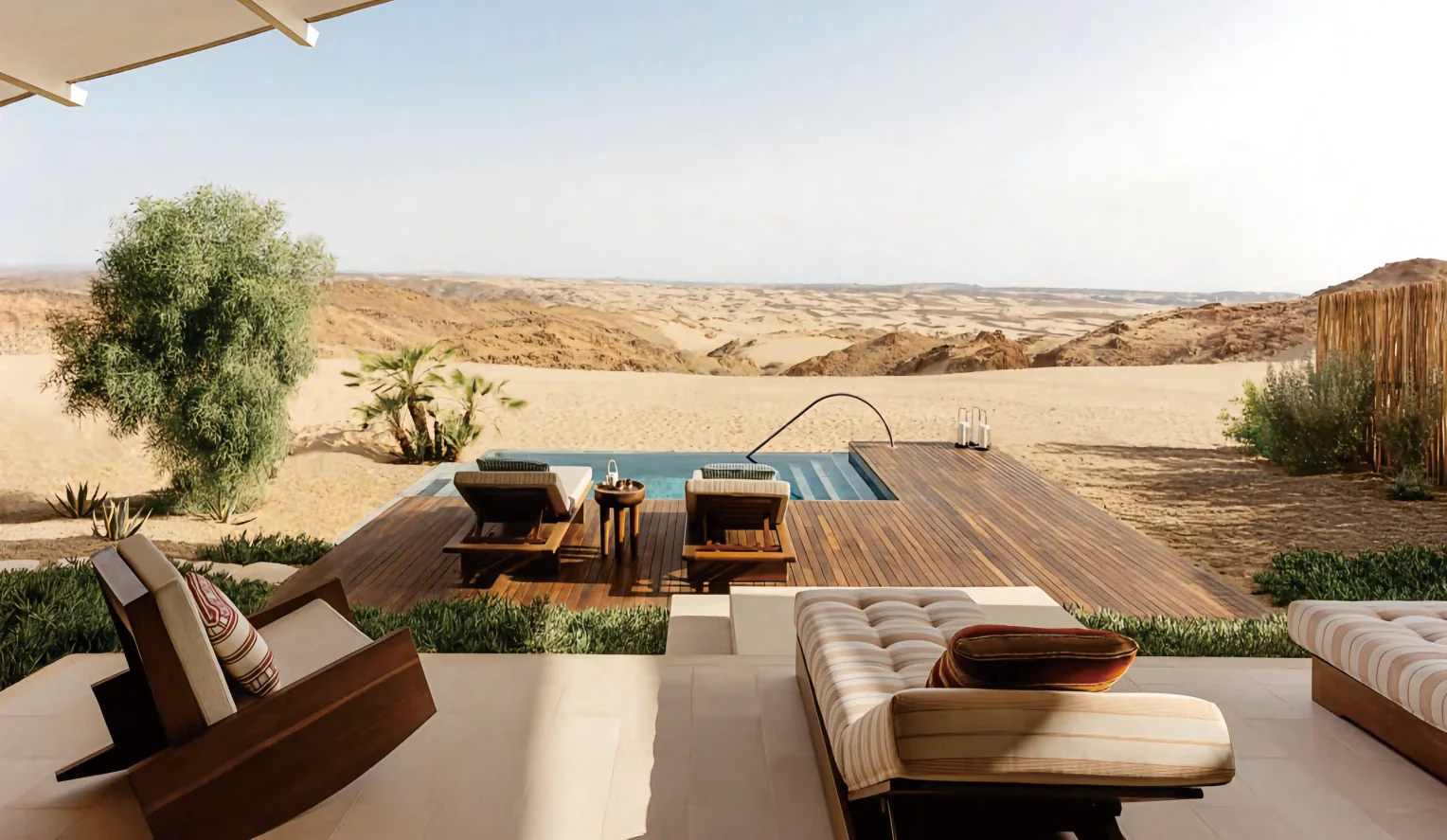 Resort outdoor lounge with orange upholstered seating overlooking desert dunes
