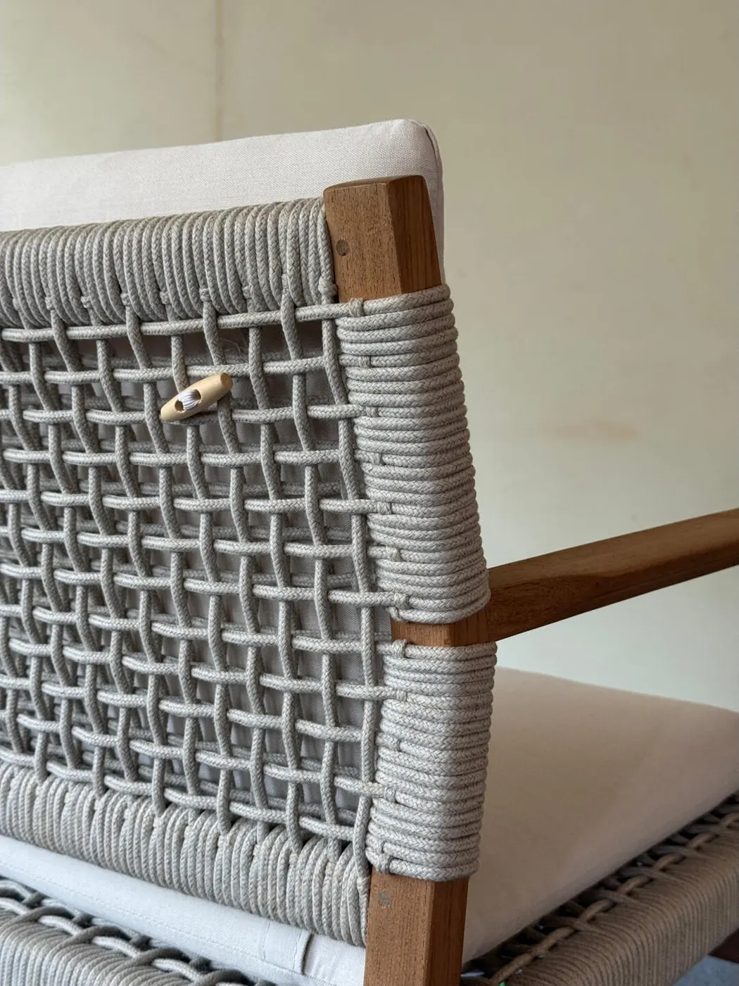 Close-up of rope weave over an aluminium outdoor chair back showing tension and hidden ends