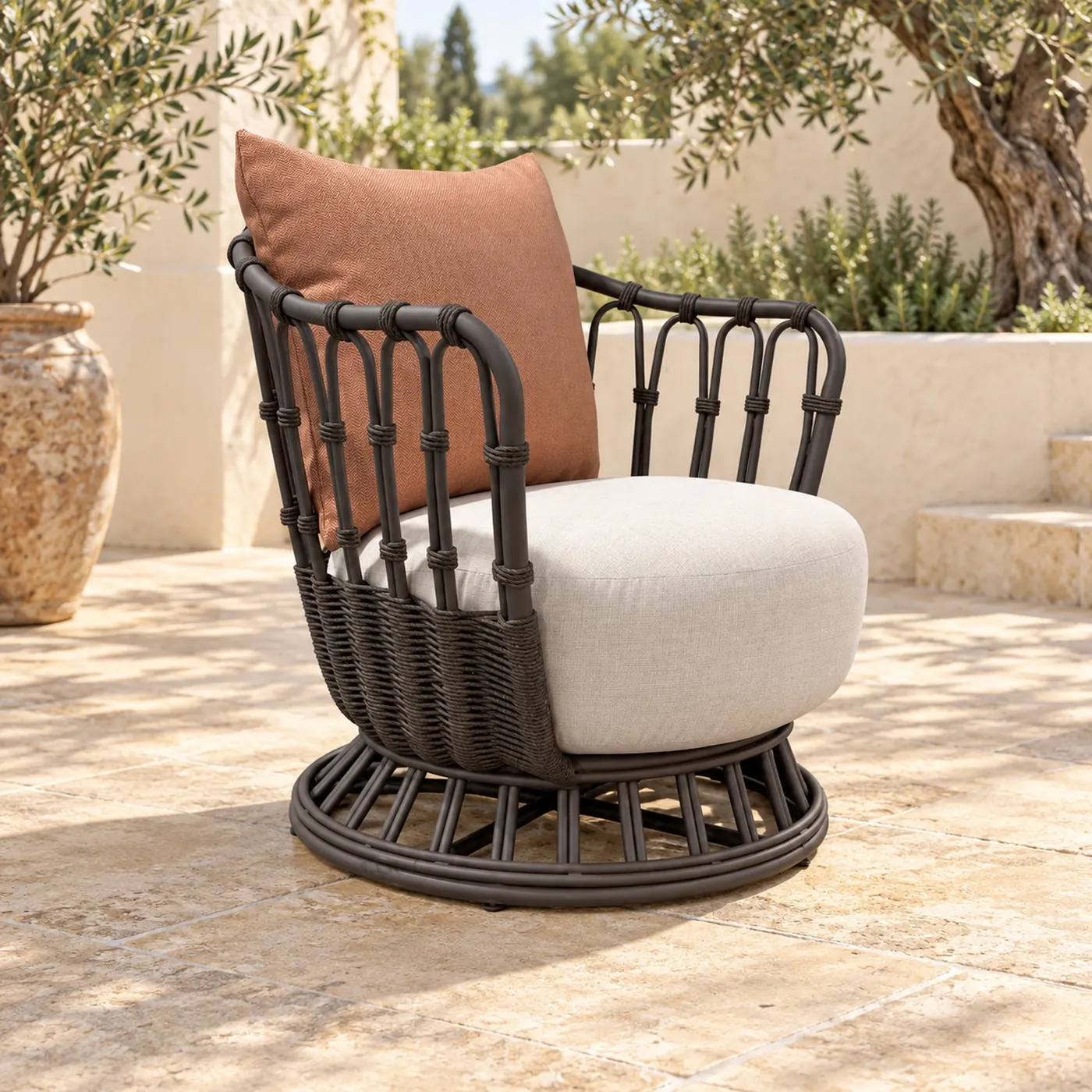 Woven rattan outdoor swivel armchair with terracotta cushion