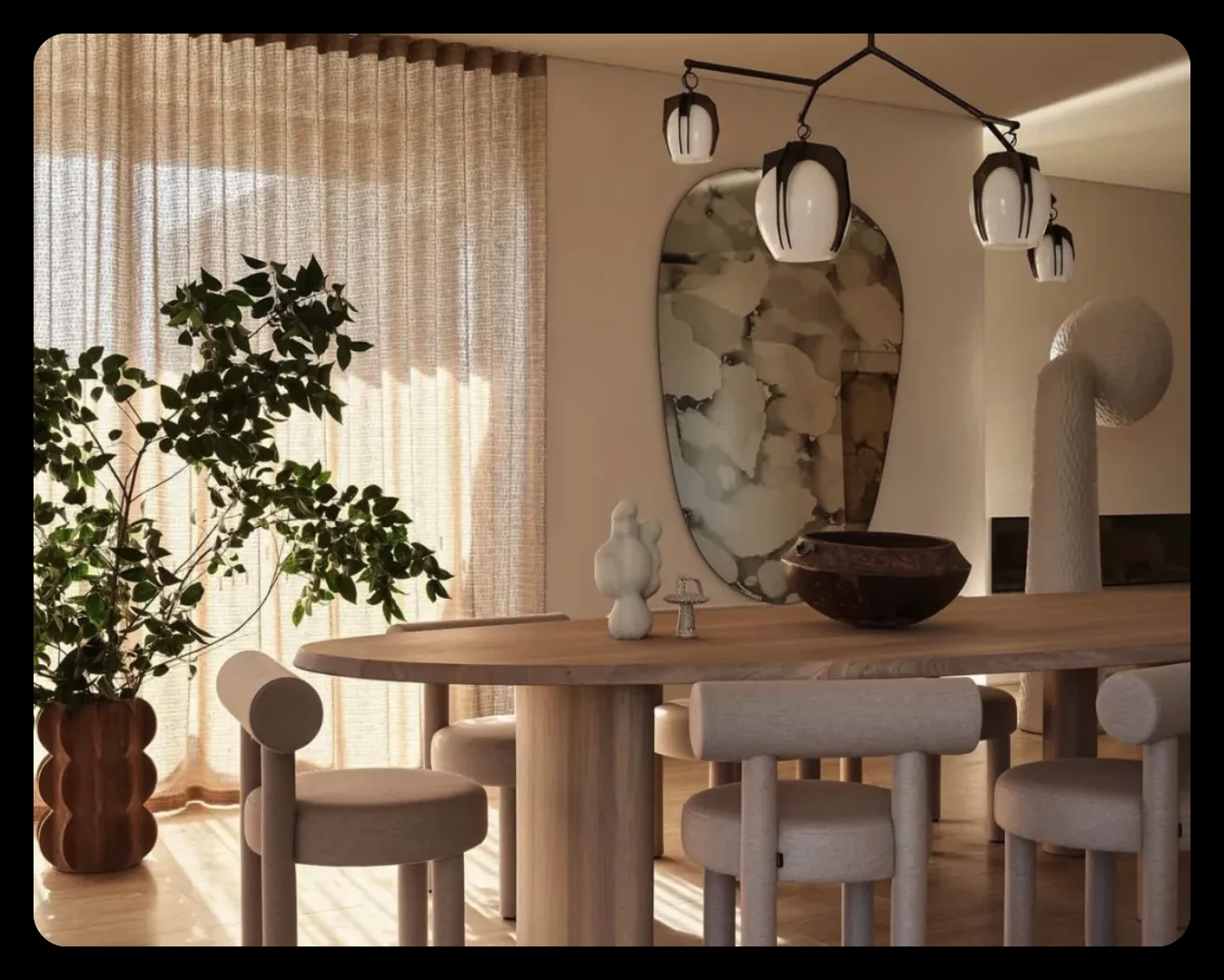 Dining setting with sculptural pendant lights, curved chairs and decor objects