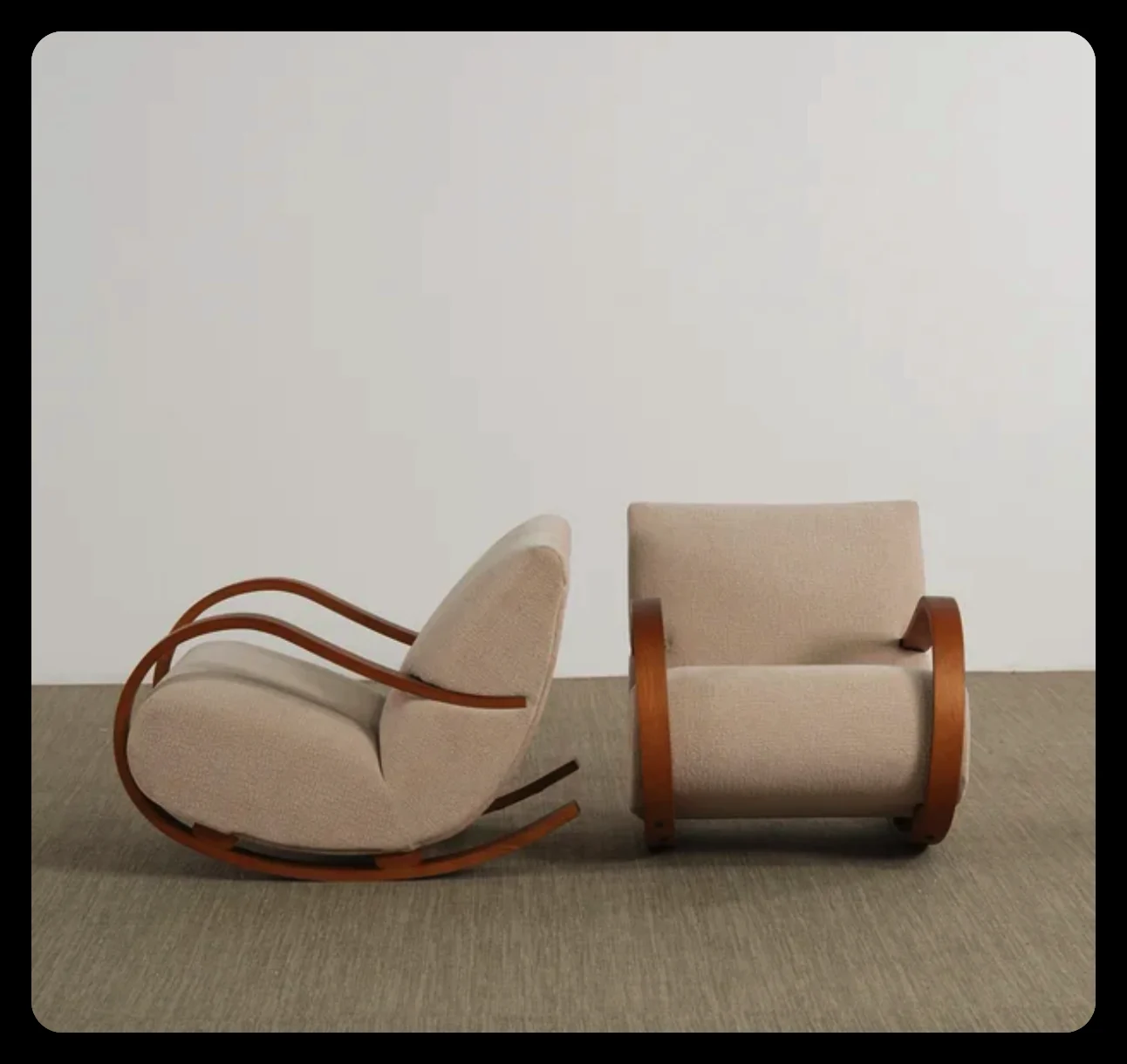 Pair of bentwood lounge chairs with cream upholstery and curved timber frames