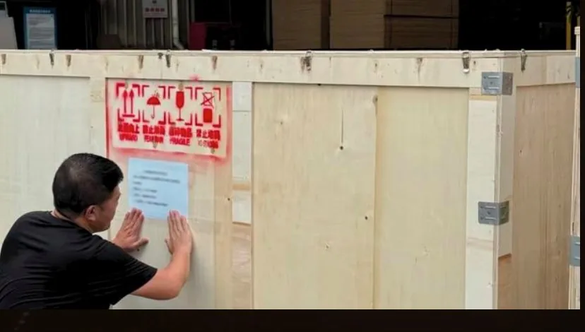 Wooden crate being labelled before export