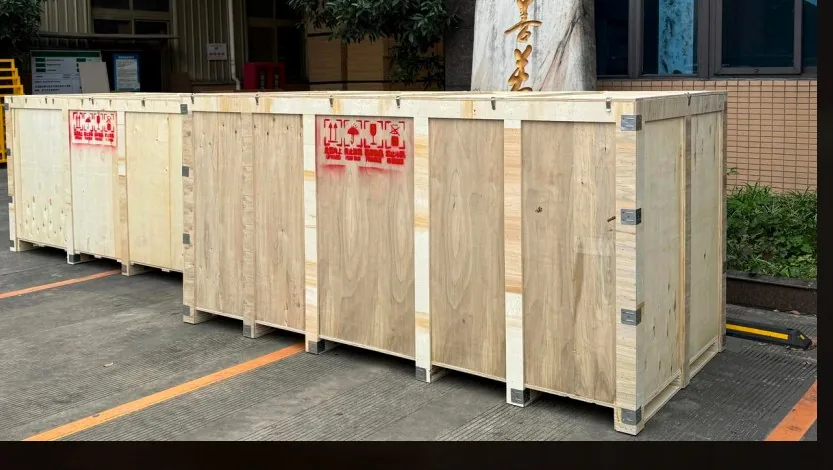 Plywood export crates with printed shipping marks lined up outside a Foshan factory