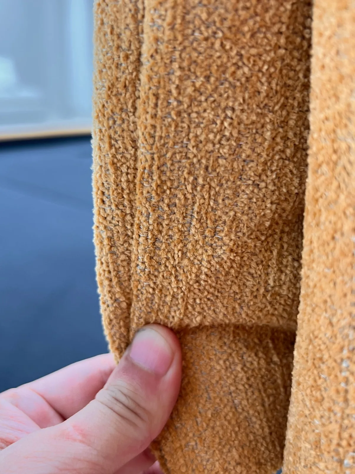Inspector checking a bouclé seam by hand