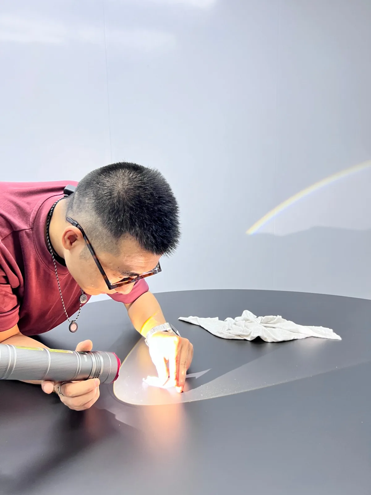 Table top checked under a raking torch light