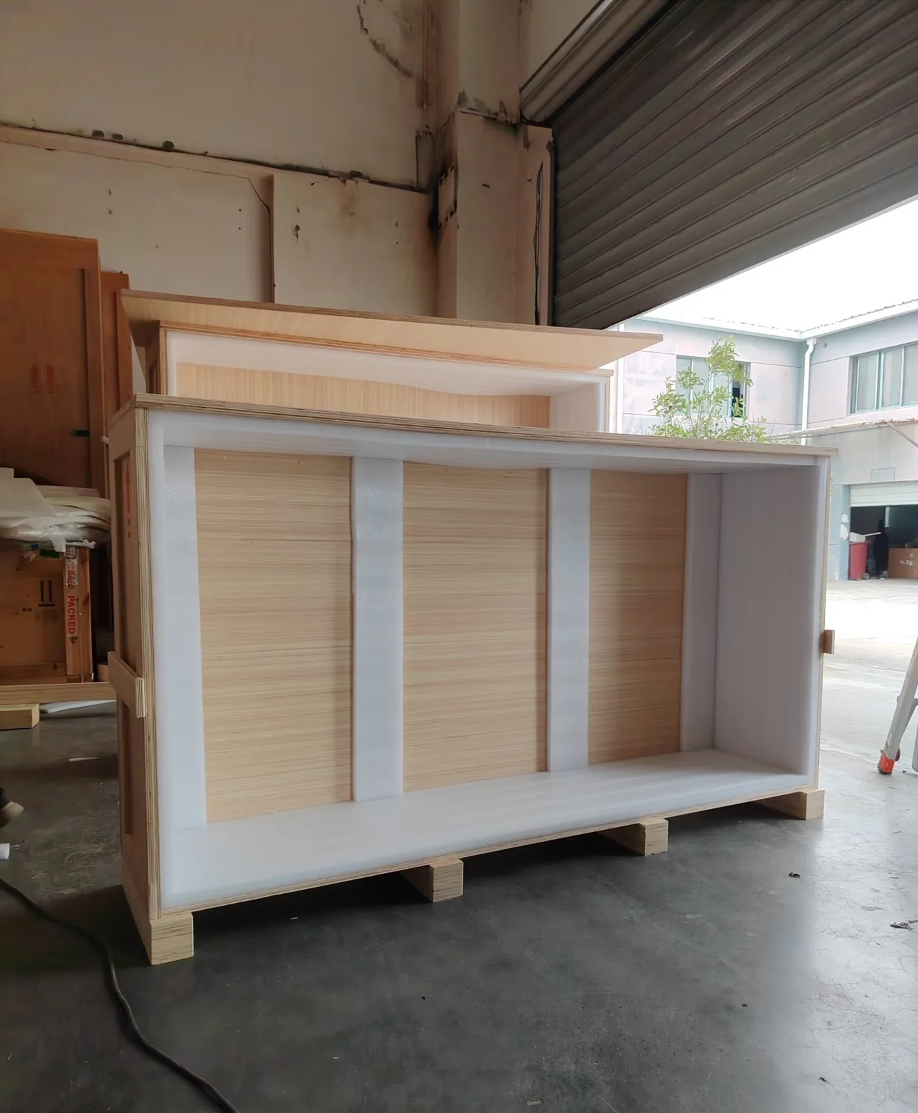 Plywood export crates marked for loading; stone tops travel this way