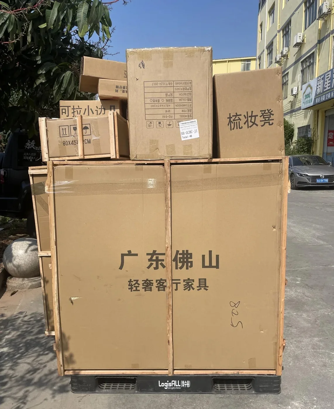One customer's Foshan furniture consolidated outside a Guangzhou warehouse before loading