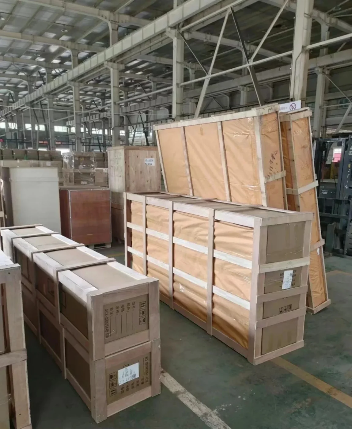 Rows of framed furniture cartons and long timber frames in an export warehouse ready for loading
