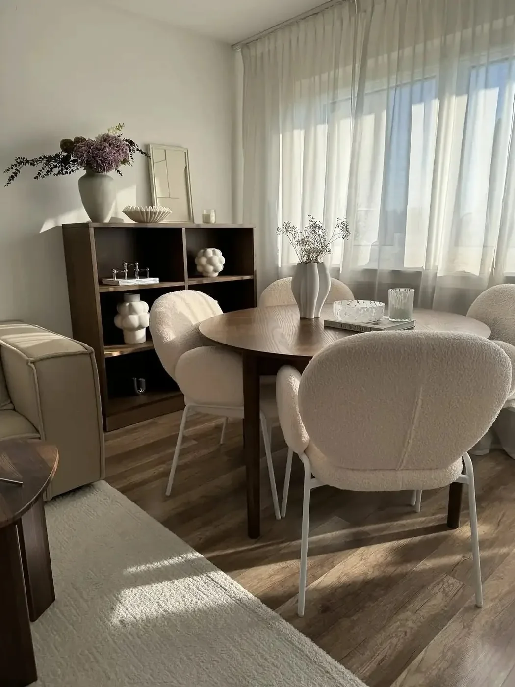 A London flat living room furnished with a grey sofa, round marble coffee table and wool rug shipped from China