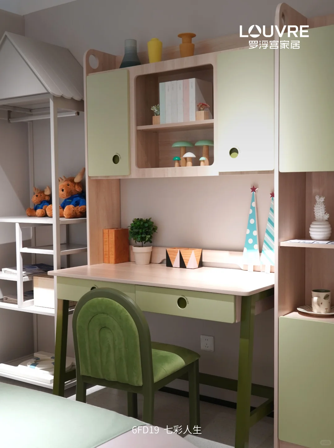 Pale timber and green children’s desk, chair and storage shelving beside a white bed ladder.
