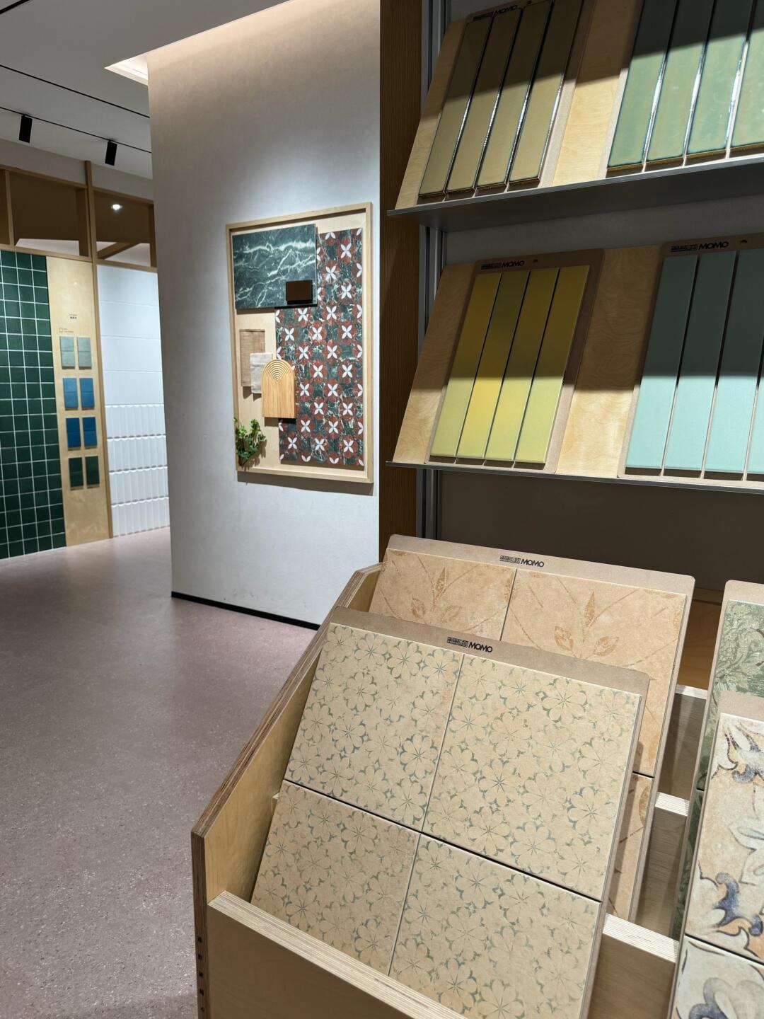 Branded sample boards displaying muted decorative patterns and coloured rectangular tiles.