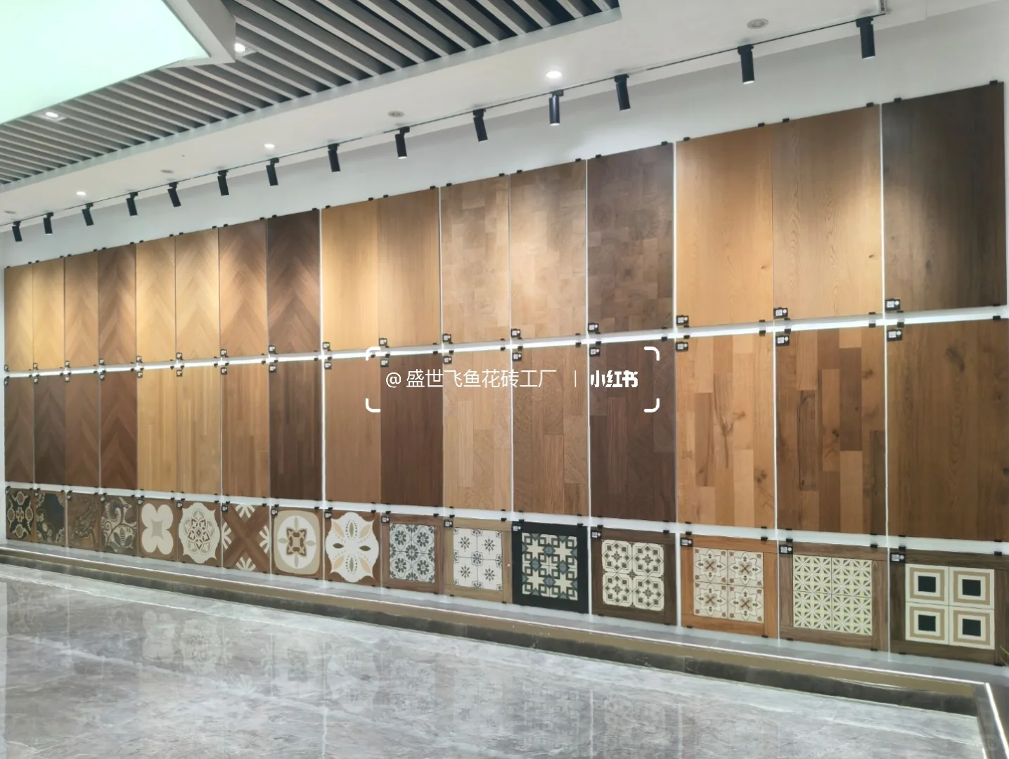 Showroom wall of warm wood-look tile panels with smaller decorative patterns along the bottom.