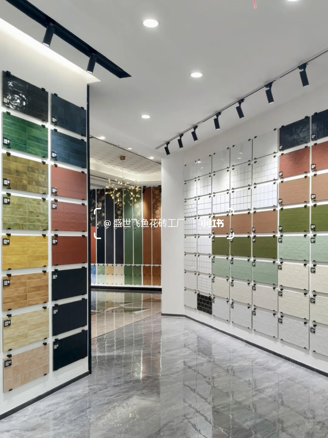Showroom corner lined with glazed rectangular tile samples in muted green, pink, yellow and white.