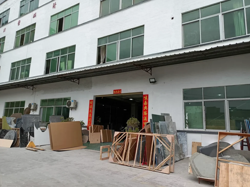 Furniture factory exterior with wooden crates and sofa frames stacked in the yard