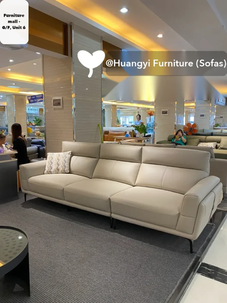 A leather three-seater on a Foshan sofa maker's showroom floor; the maker says length and colour can be changed to order.