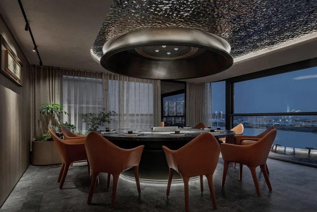 Executive meeting and dining room with a large round table and leather chairs at Yudao Home