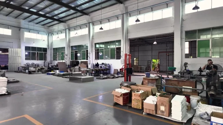 Production hall of a Foshan furniture factory with workbenches and stock