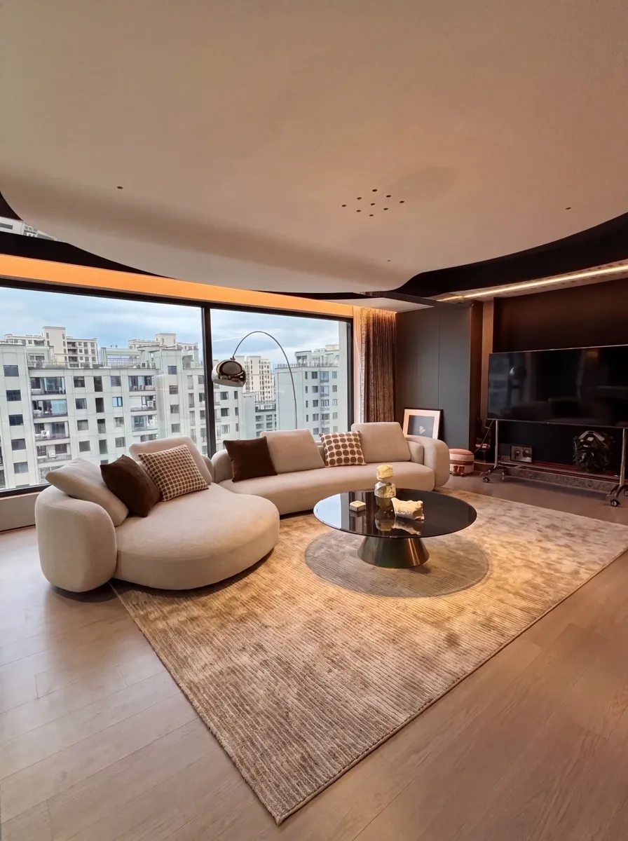A curved sofa floating in a living room: the back is as visible as the front, so it has to be finished like the front.