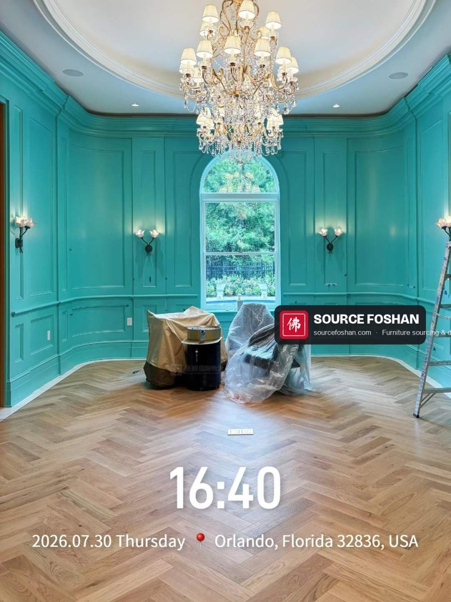 Armchairs from Foshan waiting to be unwrapped in a turquoise panelled room, Orlando