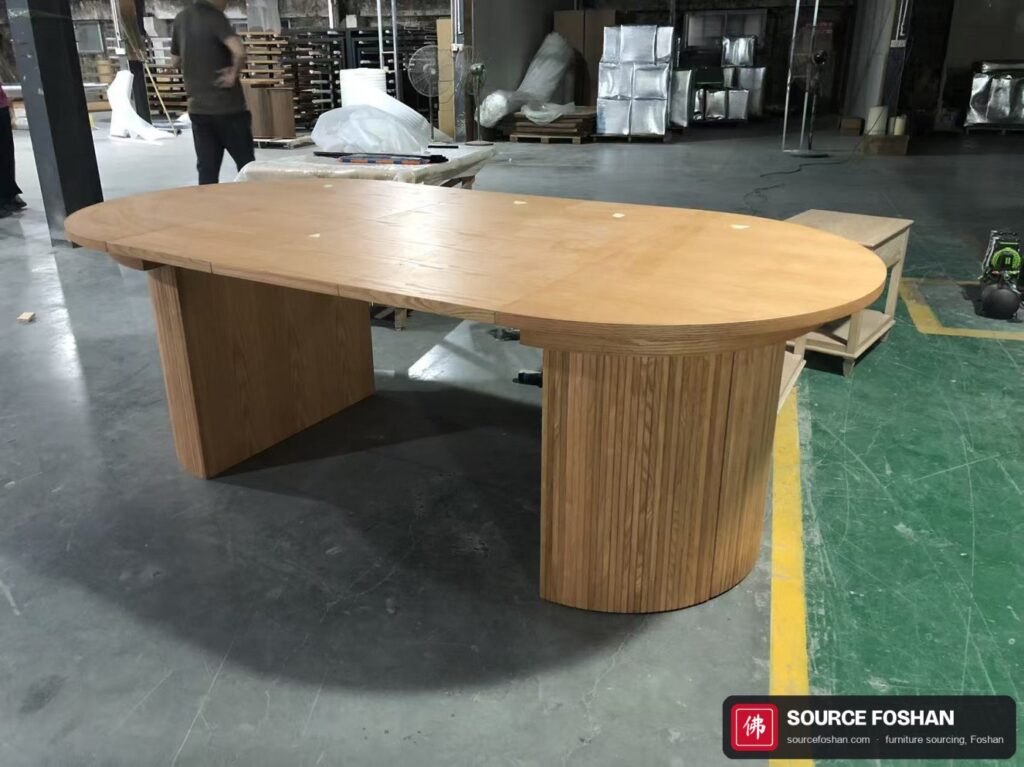 The same table extended into an oval with both leaves fitted and the seams closed