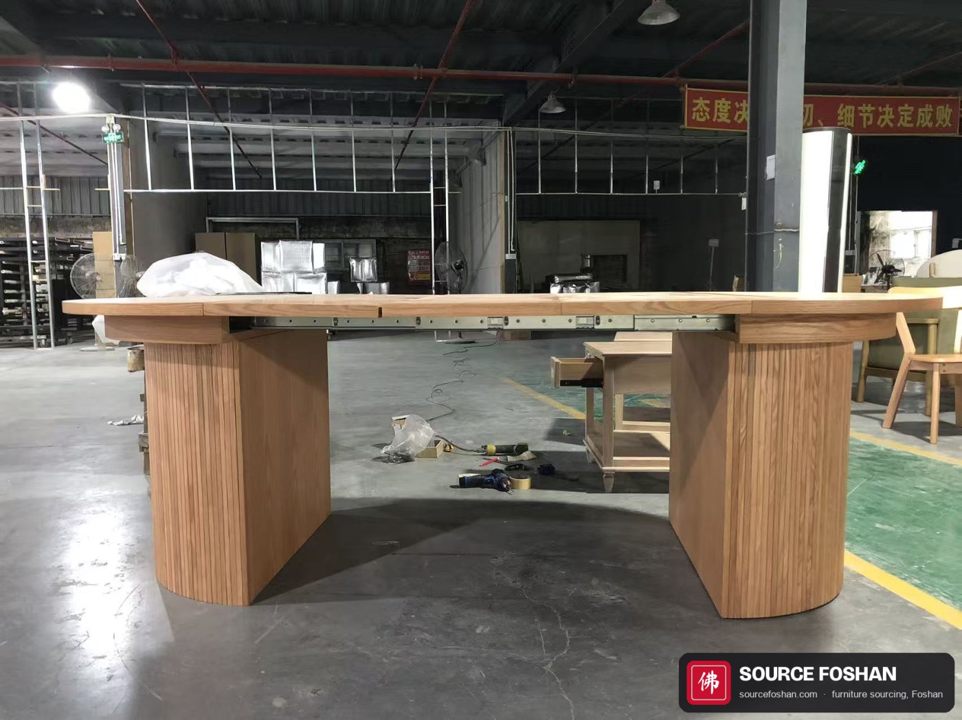 Side view of the extended table showing the slide mechanism under the top and both bases level