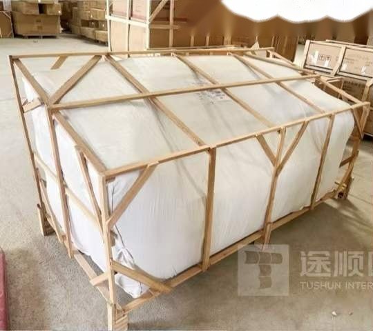 Wrapped furniture inside a braced timber crate before shipping