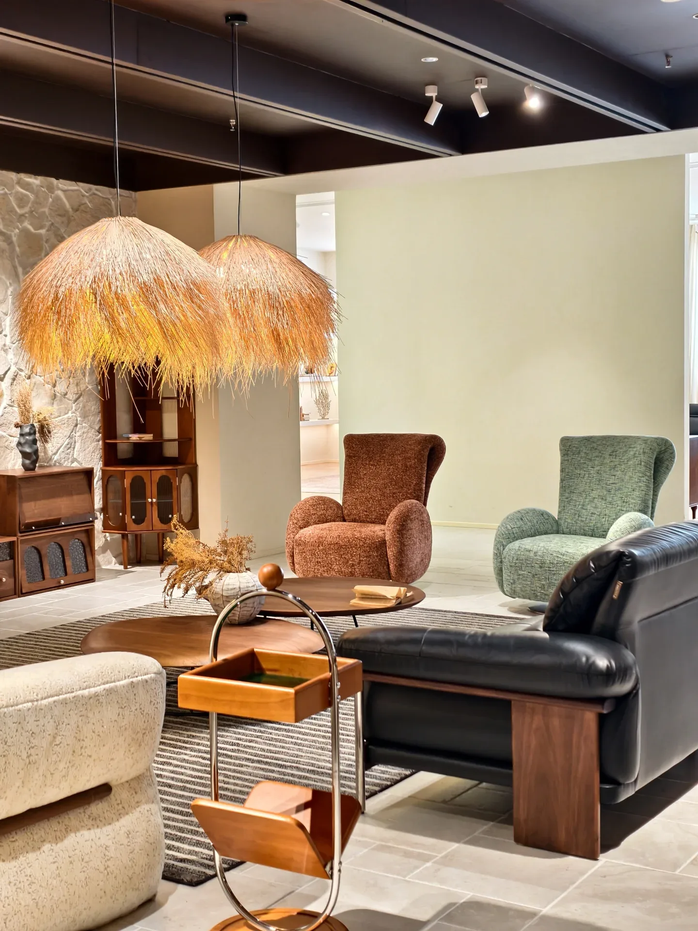 Armchairs, a leather sofa and walnut cabinets in the Jiujiang showroom. Every seller dresses its showroom well; the workshop and loading area tell.