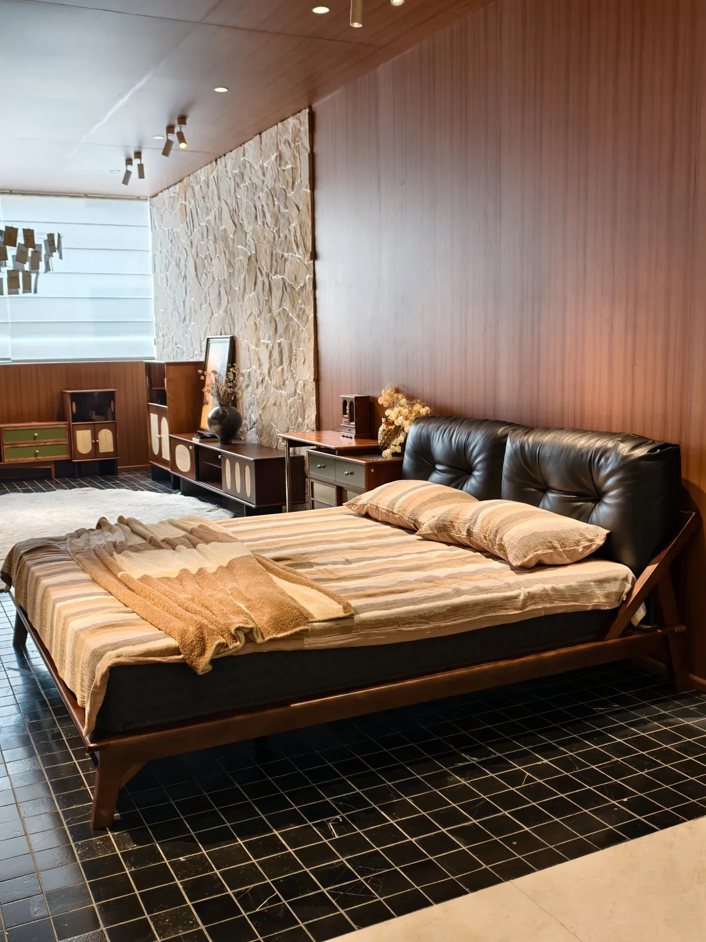 A bedroom set with a leather headboard in the same showroom, which visitors were asked to book a day in advance.
