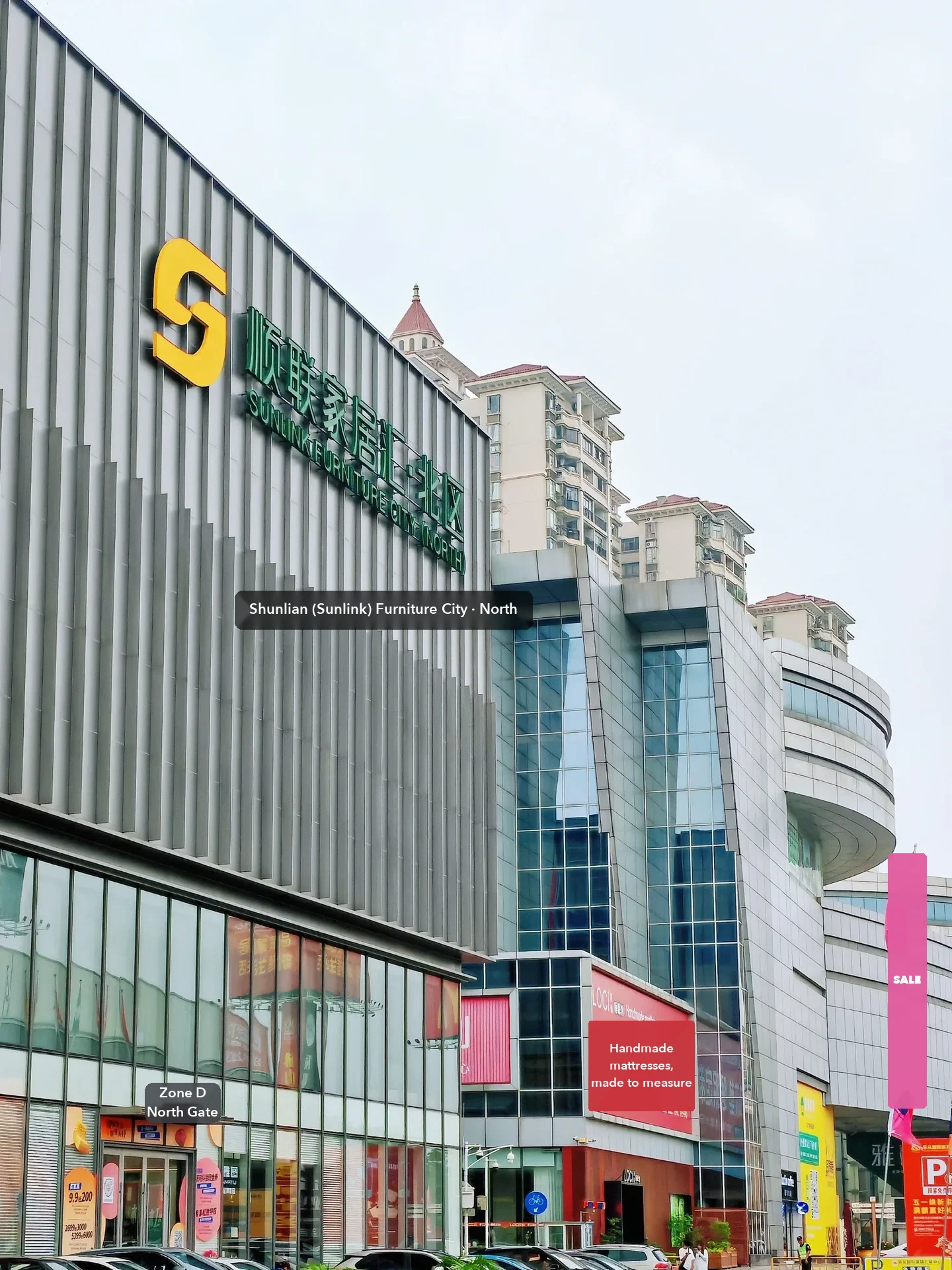 Shunlian (Sunlink) Furniture City North on the Lecong strip, photographed by a buyer: the showcase end of the road, with dressed brand showrooms.
