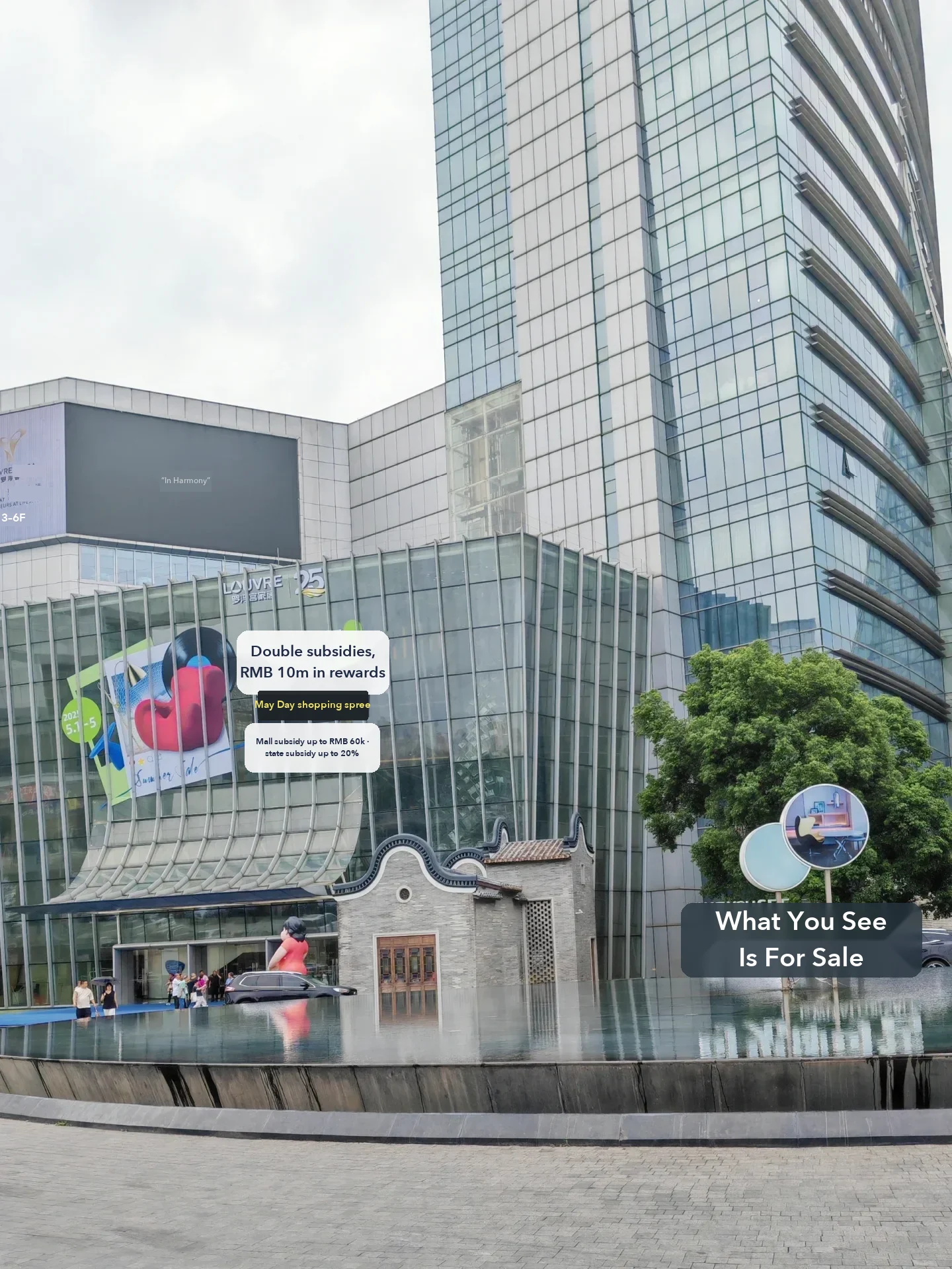 The Louvre Furniture Mall entrance during a May Day promotion, from a buyer's Lecong guide. Banners advertise mall and state subsidies, a reminder.