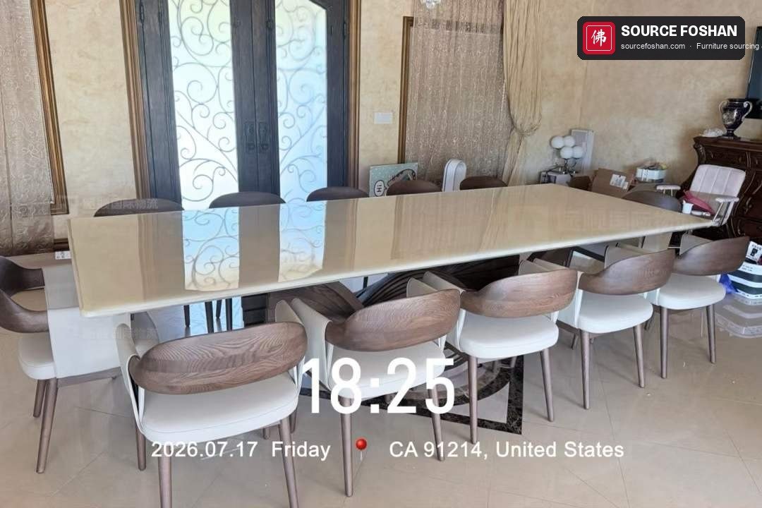Long marble dining table and ten chairs installed