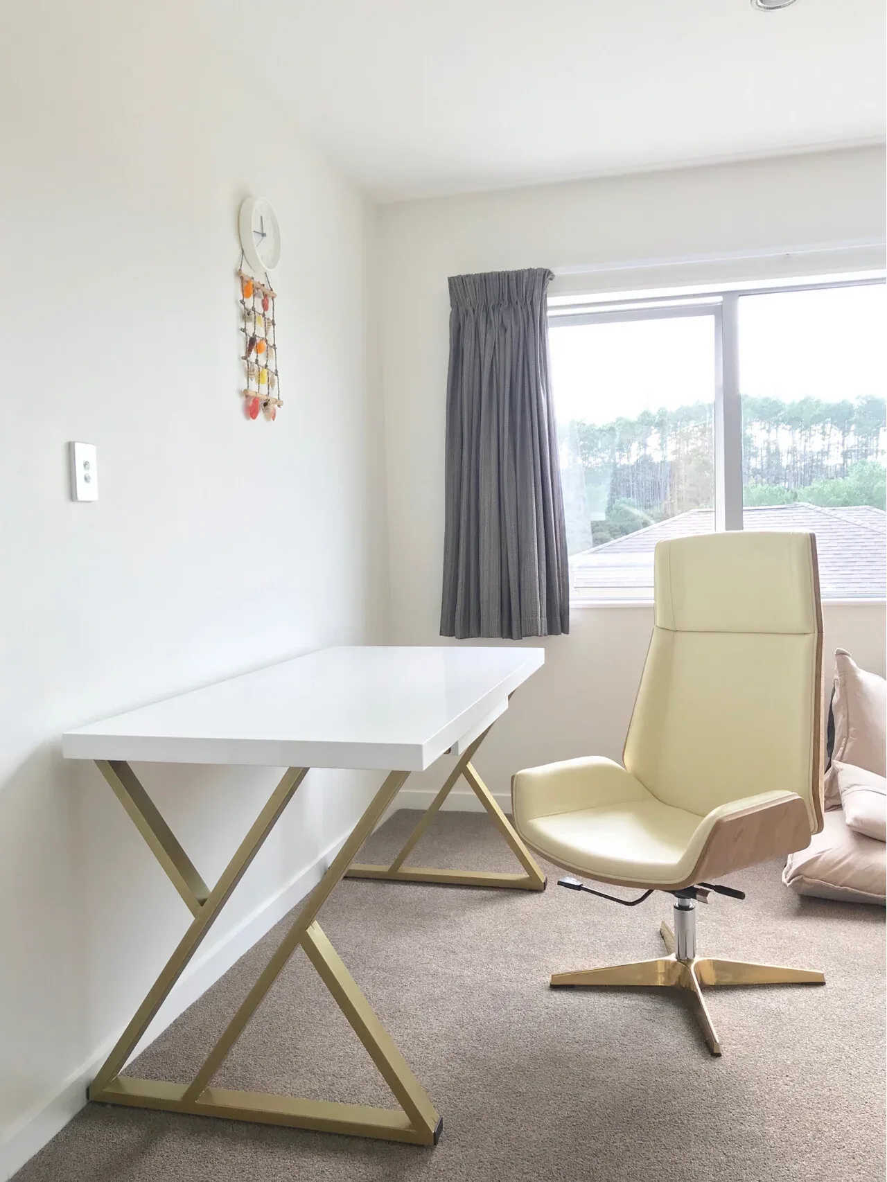 A desk and swivel chair from the same New Zealand buyer's Taobao shipment, set up in a spare room after about two months from order to delivery.